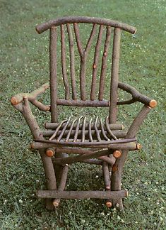 an old wooden rocking chair sitting in the grass