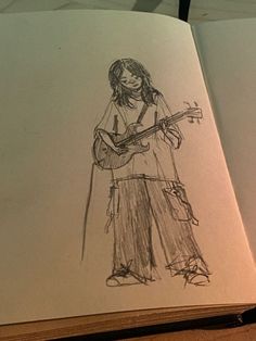 an open book with a drawing of a person holding a guitar