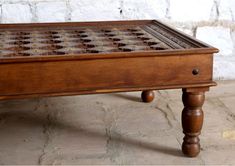 an old wooden table with a chess board on it