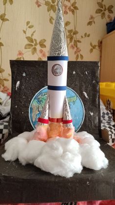 a toy rocket is sitting on top of cotton