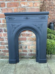 an antique fireplace surround painted dark blue