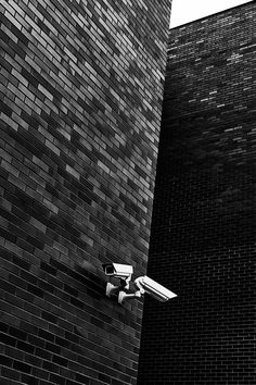 a security camera attached to the side of a brick building