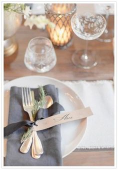 a place setting with silverware and napkins