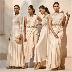 four women in dresses standing next to each other