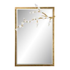 a mirror with flowers hanging from it's side and a branch in the middle