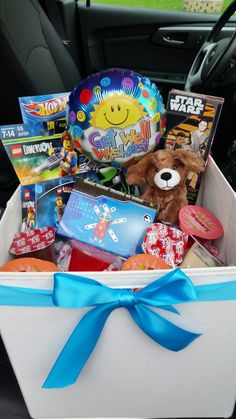 a car trunk filled with toys, books and other things to put in the back seat