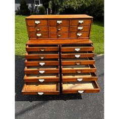 a large wooden dresser sitting on top of a parking lot