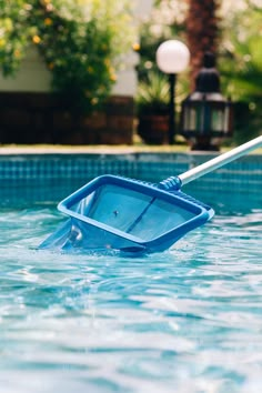 a blue wheelbarrow in the middle of a swimming pool