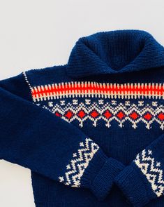 "Scandinavian Sweater  Absolutely stunning! Deep blue, white,  cherry red. Traditional Norwegian. No tag. Hand knit. No size reflected.  Closest to L Please refer to measurements! Underarm to underarm- \".   There is a little give here due to wool.  Taken when lying flat.  Double this!  Also extra give due to wool. Length - \" From top, center of back. Sleeve - \" measured from lower edge of neckline to end of sleeve. Please search \"Scandinavian\" in my shop, www.etsy.com/shop/vintagebybeth  fo Norwegian Fashion Modern, Navy Fitted Sweater For Winter, Fitted White Sweater With Fair Isle Pattern, Nordic Multicolor Winter Sweater, Fitted Navy Knitted Sweater, Navy Fitted Knitted Sweater, Fitted White Fair Isle Sweater, Boho Sweaters, Blue Nordic Knit Sweater