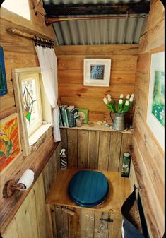 the interior of a tiny cabin with wood paneling and walls, including a blue cushion