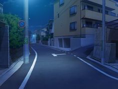 an empty street at night with no cars on the road and buildings in the background