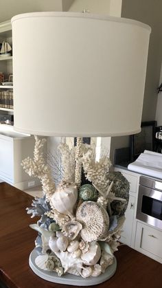 a lamp that is sitting on top of a table next to a book shelf and cabinets