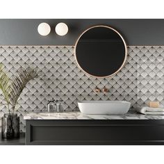 a bathroom with a round mirror above the sink