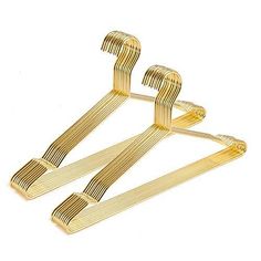 three pairs of gold metal clothes hangers