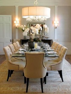 a dining room table with chairs and a chandelier