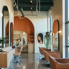 the interior of a hair salon with lots of chairs