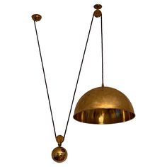 two brass pendant lights hanging from the ceiling