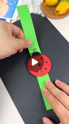 someone is making a paper ladybug craft