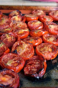 sliced tomatoes on a baking sheet ready to be cooked in the oven or grilling