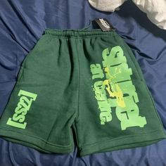 A Hole In One Pocket Green Summer Bottoms For Leisure, Green Bottoms For Leisure In Summer, Green Leisure Bottoms For Summer, Green Leisure Shorts For Summer, Yellow Leisure Bottoms For Summer, Green Bottoms With Letter Print For Streetwear, Green Cotton Leisure Bottoms, Trendy Green Leisure Bottoms, Trendy Green Bottoms For Leisure