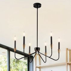 a black chandelier hanging over a dining room table