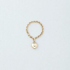 One of our best sellers, this Puffed Heart Ring on a roll chain ring brings a new take on a fun charm ring. Details:Dainty puffed heart charm dangling from a rolo chain ring - puffed heart 1/4" - delicate gold rolo chain - 14k yellow gold Free Shipping on Domestic Orders Materials: 14k Yellow Gold Need your ring bigger than whats offered? An additional fee will be applied to ring orders larger than size 8. Please contact us for exact pricing or feel free to place your order and we will send you Ring With Dangling Charm, Charm Rings Dangle, Dangle Rings, Personalized Gold Rings, Dangle Ring, Chain Ring Gold, Wire Jewelry Making, Charm Ring, Puffed Heart