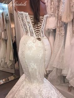 the back of a wedding dress in front of a mirror