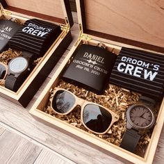 two wooden boxes filled with different types of men's grooms watches and sunglasses