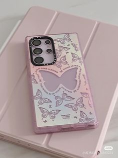 a pink phone case with butterflies on it