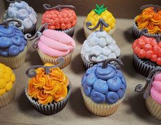 there are many cupcakes with different colored frosting