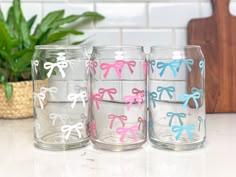 four glasses with bows on them sitting on a counter