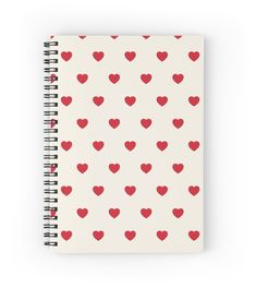 a spiral notebook with red hearts on it