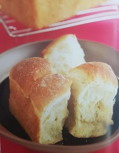 two pieces of bread sitting on top of a black plate