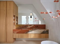 a bathroom with two sinks and a bathtub next to it in a room that looks like an attic