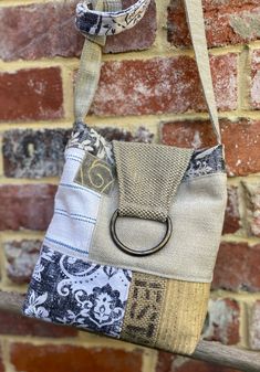 a bag hanging on a brick wall with a ring in the middle and fabric around it