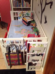 a child's room with a crib, bookshelf and toys in it