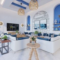 a living room filled with white furniture and lots of blue accents on the walls,