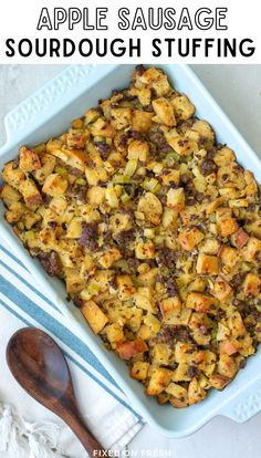 an apple sausage stuffing in a blue casserole dish