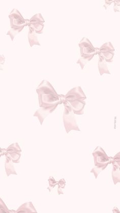 a pink wallpaper with large bows on it