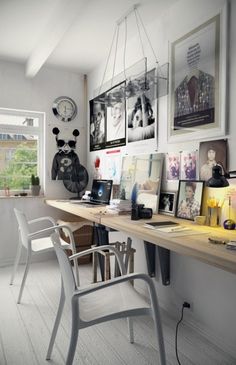 a desk with many pictures on the wall