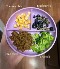 a purple plate topped with broccoli and other foods