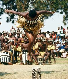 a poster with an image of a man dancing in front of a group of people