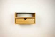 a small wooden drawer on the wall