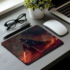 a star wars mouse pad sitting on top of a desk