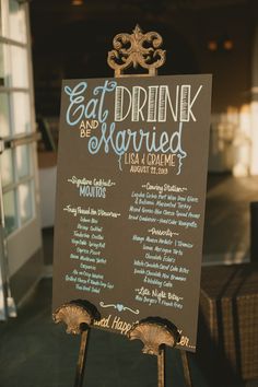 a sign that says eat drink and be married with the names of their guests on it