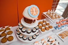 a table topped with lots of cupcakes and cakes