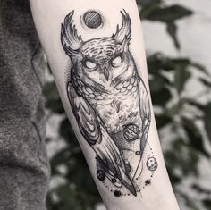 an owl tattoo on the right arm and left arm is shown in black ink, with circles around it