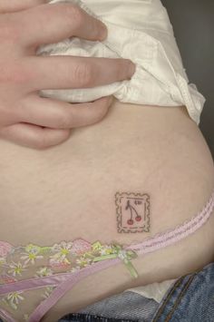 a pregnant woman's belly with a musical note tattoo on it