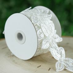 a roll of white lace sitting on top of a wooden table