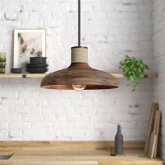 a wooden light fixture hanging from a ceiling in a room with white brick walls and shelves